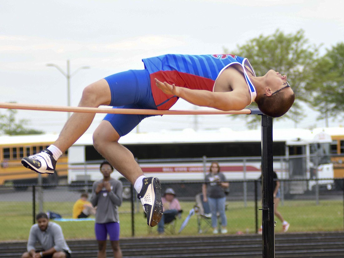 Jay County High School junior Adam Alig slips over the high jump bar at 6 feet Thursday during the sectional meet at Delta. Alig made it over the 6-foot mark on his first attempt, which ended up giving up the third-place tiebreaker with Easton Doster of Monroe Central. (The Commercial Review/Ray Cooney)