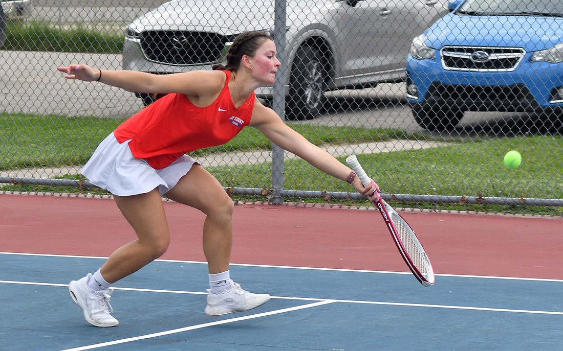 Jay County High School senior Brenna Haines reaches down to hit a tennis ball during the IHSAA Sectional 53 championship against Union City on Thursday. Haines beat Camryn Fischer in the No. 1 singles match 6-2. 6-4 to secure her fourth straight sectional title. (The Commercial Review/Andrew Balko)