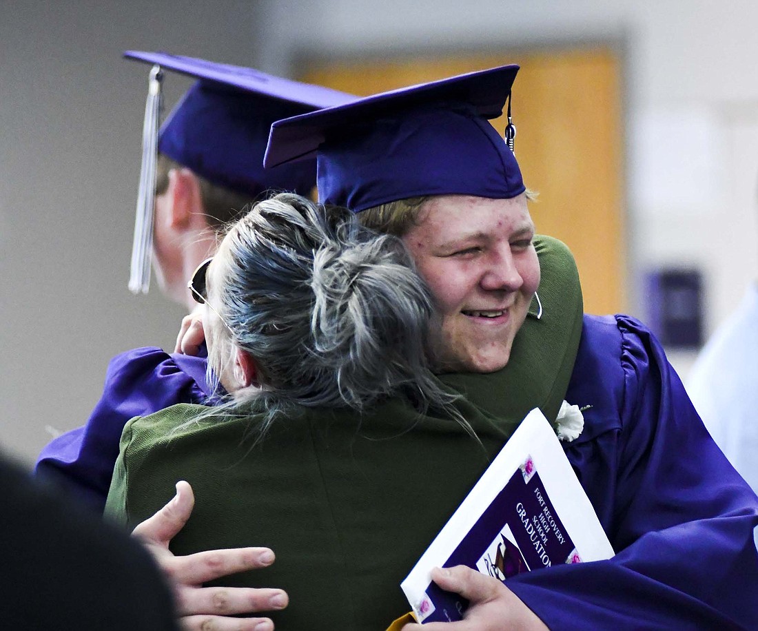 Fort Recovery High School’s Owen Knapke gets a hug after Sunday’s graduation ceremony at Fort Site Fieldhouse. He was one of 77 FRHS students in the Class of 2024 who were encouraged to chase their own expectations, remember the lessons they have learned thus far and seek to make a positive impact on the world. (The Commercial Review/Ray Cooney)