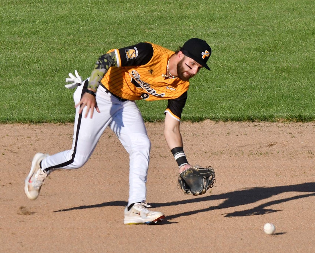 Portland Rockets’ second baseman Cameron Pratt charges a ground ball in the season opener on Saturday. The Rockets finished 1-2 over the weekend against the South Bend Royals. (The Commercial Review/Andrew Balko)