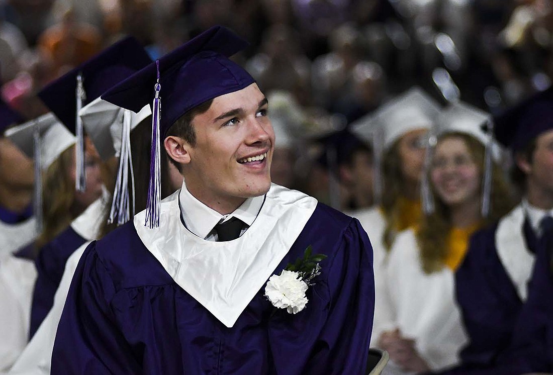 Nate Jutte grins while watching the senior memories video during Sunday’s graduation ceremony at Fort Recovery High School. Jutte is one of 77 graduates in the Class of 2024. (The Commercial Review/Ray Cooney)