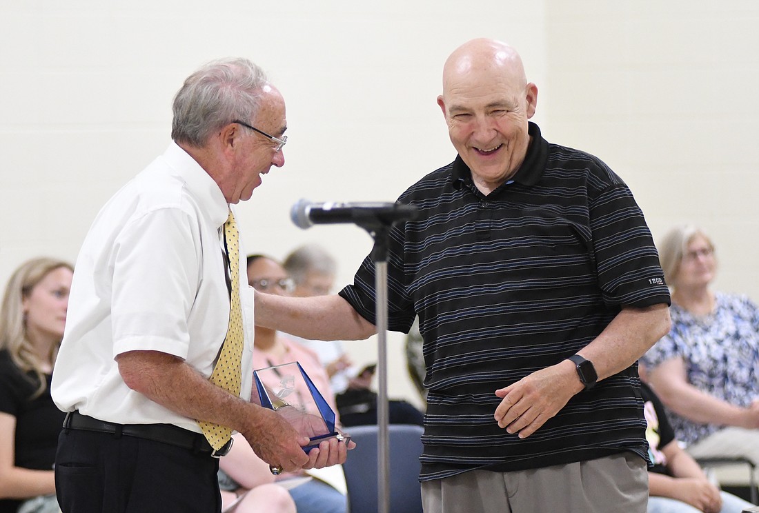 Jay School Board member Phil Ford and former Jay County High School band director Dave Humbert share a laugh Monday during the Patriot Service Award ceremony. Humbert joined Bob Lyons and Ingrid Saxman in receiving the honor this year. It goes to those “who have significantly contributed to the mission of the Jay School Corporation over an extended period of time.” (The Commercial Review/Ray Cooney)