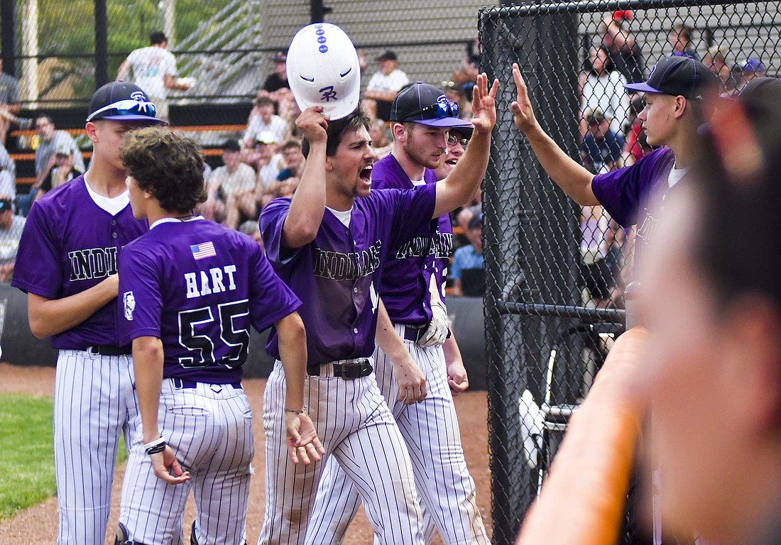 Troy Homan, a senior at Fort Recovery High School, celebrates as he walks back to the dugout after Caden Homan’s double got him and Reece Wendel to score during Wednesday’s district semifinal at Coldwater. (The Commercial Review/Andrew Balko)