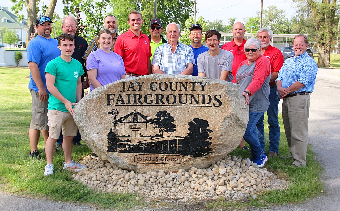 Rural Portland resident Mike Leonhard recently donated an engraved stone to Jay County Fairgrounds. The rock, pictured above with Leonhard in the center surrounded by Jay County Fair Board members, will be placed at the fairgrounds’ front entrance along Votaw and Morton streets. (Photo provided)