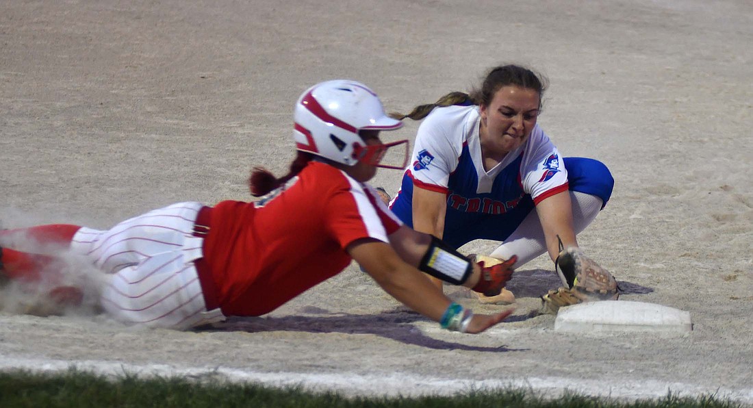 Jay County High School first baseman Jozey Shimp dives to beat Mississinewa’s Allie Trejo to the bag for the final out of the IHSAA Class 3A Sectional 24 semifinal on Thursday. Shimp also hit a three-run home run in the first inning to help secure the 6-4 victory that got the Patriots back to the sectional championship game for the first time since 2010. (The Commercial Review/Andrew Balko)