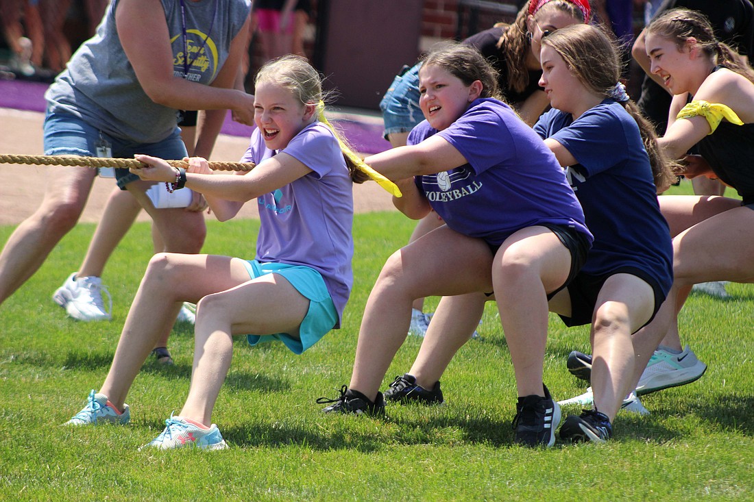 Katelyn Siefring, Addalyn Roessner, Cora Pearson and Stella Patch pull during the tug of war competition Friday at Fort Recovery Middle School. Students faced off in various field day activities on their last day of the school year. (The Commercial Review/Bailey Cline)