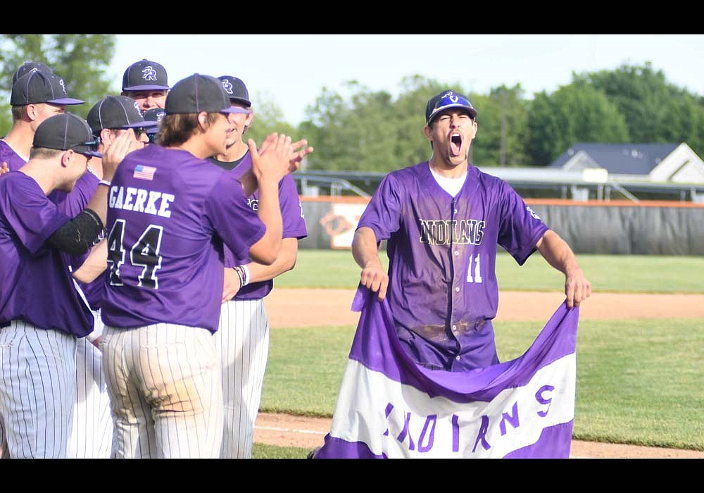 The Fort Recovery High School baseball team won the regional championship and earned a state berth Friday. Pictured, Troy Homan waves a Fort Recovery Indians flag after the baseball team defeated Leipsic 5-1 in the regional title game at Elida. (The Commercial Review/Ray Cooney)