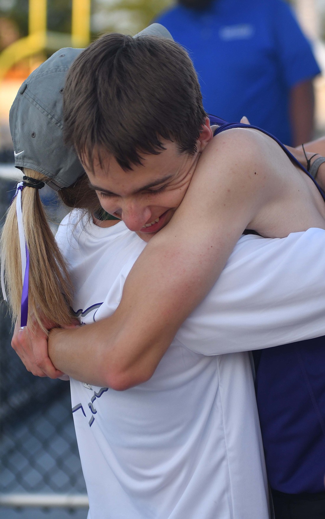 The Fort Recovery High School senior Trevor Heitkamp broke a school record in his final career race. Pictured, Heitkamp hugs coach Christy Diller following his school-record effort in the 3,200-meter run at the OHSAA Division III Track and Field State Finals at Welcome Stadium in Dayton. (The Commercial Review/Andrew Balko)