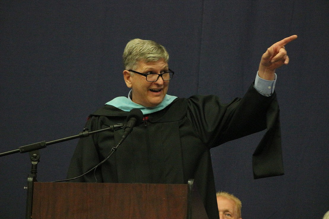 Jay School Corporation superintendent Jeremy Gulley asks parents and guardians to stand Sunday during Jay County High School’s commencement. Gulley noted a number of those standing were once students of his own years ago while he was a junior high history teacher. “That warms my heart, it really does,” he said. (The Commercial Review/Bailey Cline)