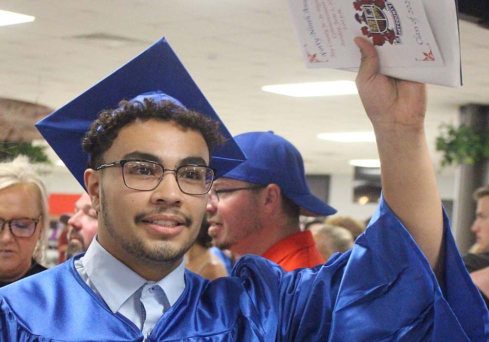 Juaquin Flores waves with his diploma and program Sunday afternoon following the Jay County High School commencement ceremony. The school said goodbye to the 208 members of the Class of 2024. (The Commercial Review/Bailey Cline)