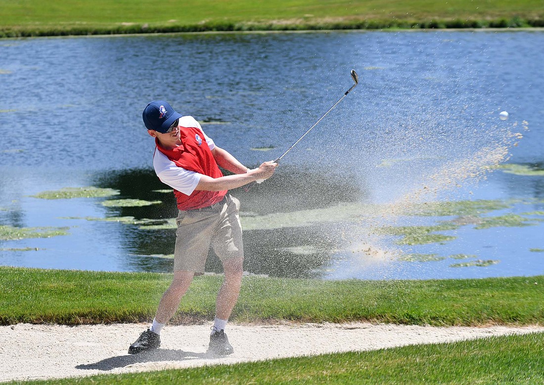 Caleb DeRome, a senior at Jay County High School, hits out of the bunker on the 18th hole at The Players Club on Thursday afternoon during the IHSAA Regional 4 meet hosted by Muncie Central. DeRome finished tied for 59 with 88 strokes and came up 14 short of a state berth. (The Commercial Review/Andrew Balko)