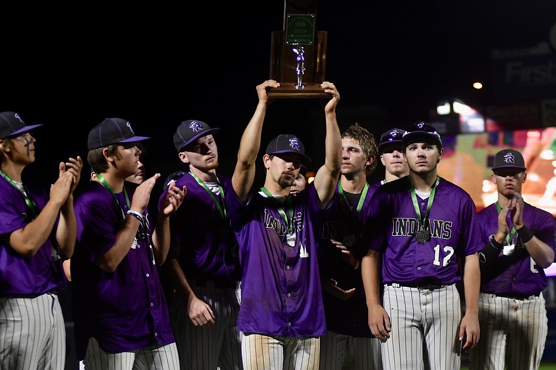 The Fort Recovery High School baseball team, which was sub-.500 heading into the tournament, advanced all the way to play for the Division IV state championship Sunday evening at Canal Park in Akron. Pictured above, FRHS center fielder Troy Homan solemnly holds up the second-place trophy following the Indians’ 3-2 loss to No. 1 Hiland in the state title game. (The Commercial Review/Andrew Balko)