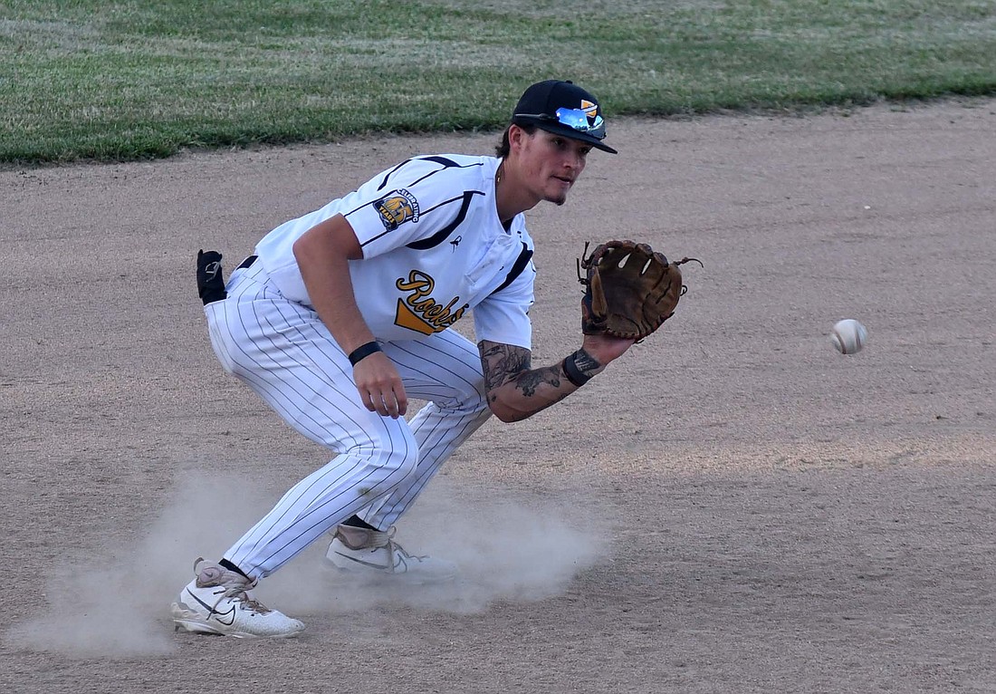 Portland Rockets third baseman Aidyn Coffey fields a chopping ground ball early in the 11-3 win over the Muncie Chiefs on Tuesday. Coffey hit a two-run blast in the third inning to tie the game and give the offense a jump start. (The Commercial Review/Andrew Balko)