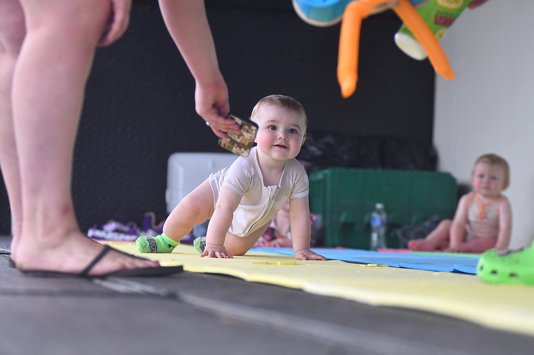 Fort Recovery Harvest Jubilee kicked off Thursday. Pictured above, 11-month-old Tucker Trumbull is enticed forward by an iPhone, a cup of lemonade and some toys during the Diaper Derby. (The Commercial Review/Andrew Balko)