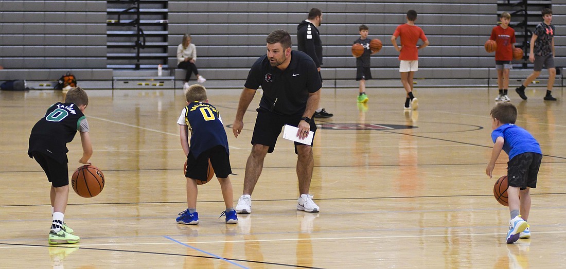 A 2008 Jay County High School graduate and former assistant boys basketball coach Aaron Daniels instructs a small group of kids during a ball handling drill during the Blackford High School basketball youth camp. Daniels became Blackford’s head basketball coach on May 21. (The Commercial Review/Ray Cooney)