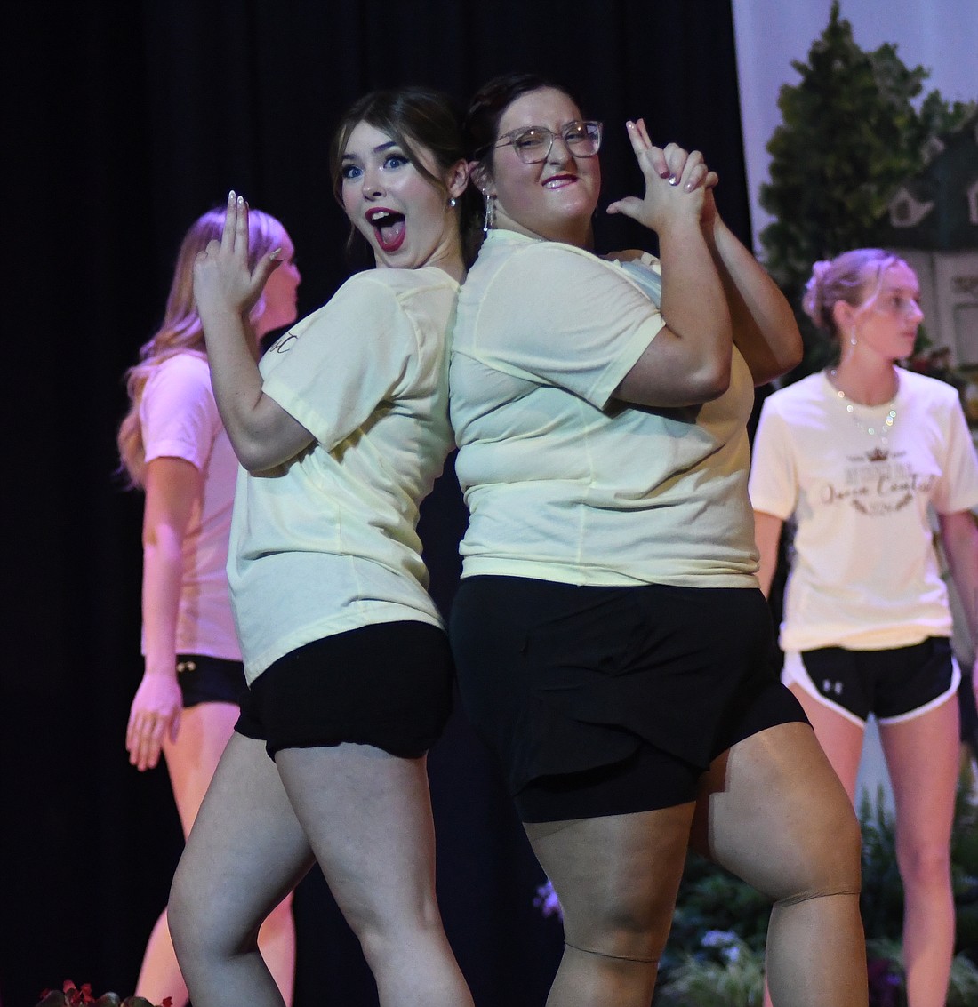 Inara Sanderson (left) and McKenna Vore strike a “Charlie’s Angels” pose Sunday night during a performance by the 2024 Miss Jay County Fair Queen contestants and 2023 court during the pageant at Jay County Junior-Senior High School. (The Commercial Review/Ray Cooney)