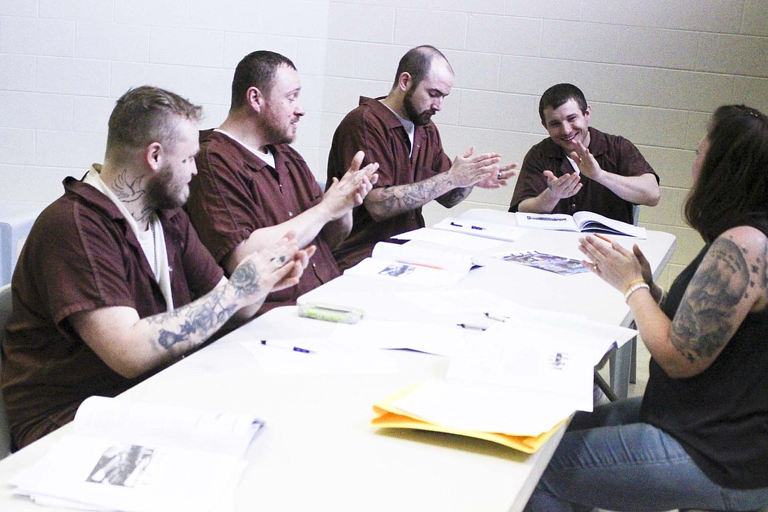 A Better Life — Brianna’s Hope recently started offering Moral Reconation Therapy at Jay County Jail. Pictured above, participants Payton Folkerth, Steven Taylor, Trevin Miller and Coby Green cheer after completing an exercise in May with facilitator Kandi Sapp. (The Commercial Review/Bailey Cline)