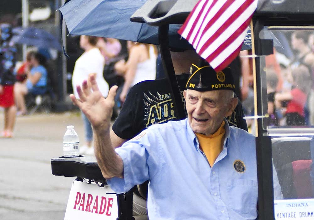 Glen Bryant of Portland waves while representing Jay County Korean War veterans as the grand marshals of Thursday's Jay County 4th of July parade. Festivities following the rainy parade included afternoon activities at Jay County Fairgrounds and fireworks at dusk. (The Commercial Review/Ray Cooney)