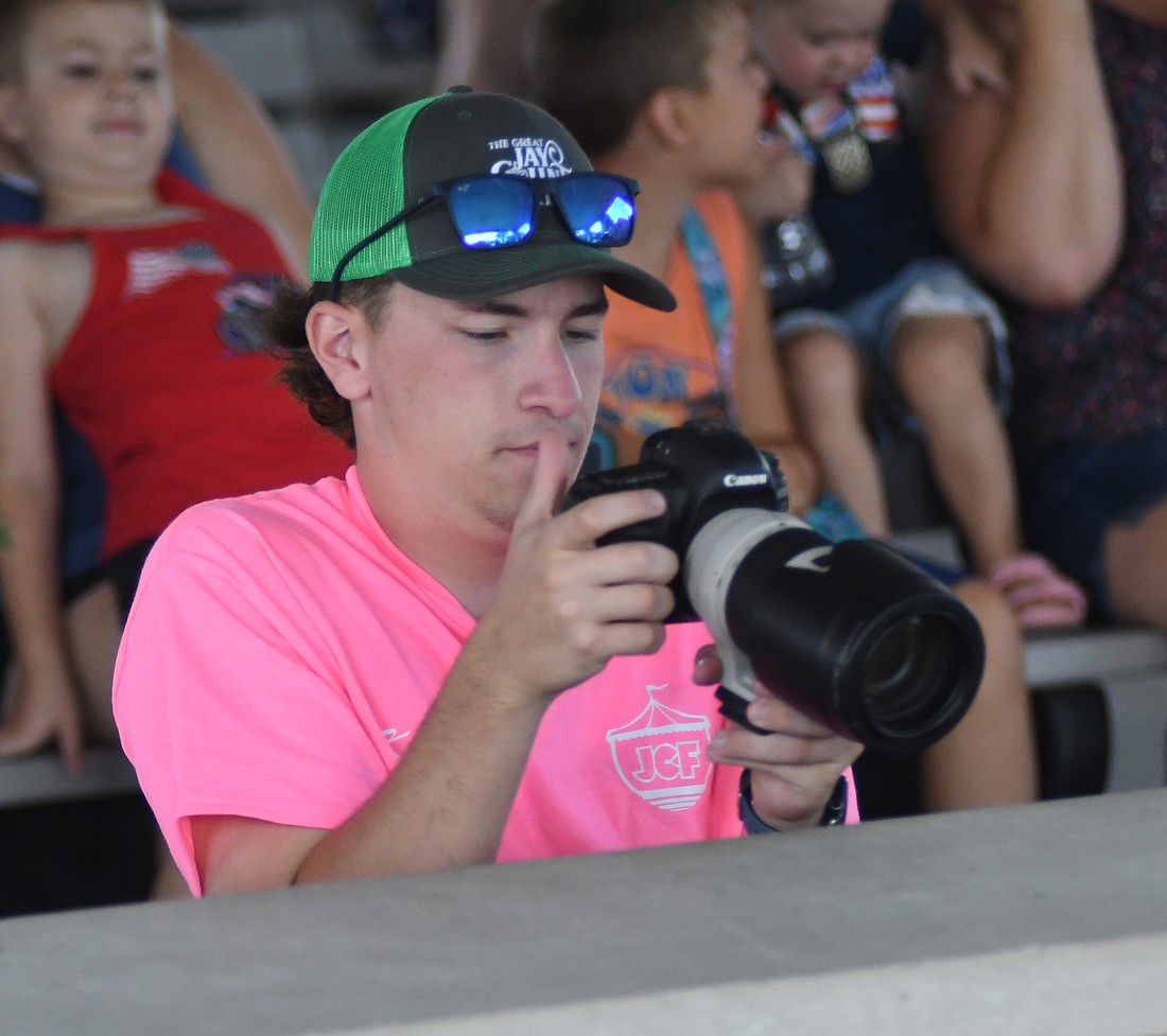 Jay County Fair sponsorship intern Kaden Khayyata reviews some of his photos during the baby contest Saturday morning at the Farmer’s Building. In his intern role, Khayyata helped to secure sponsors for the fair and this week is acting as a junior fair board member. (The Commercial Review/Ray Cooney)