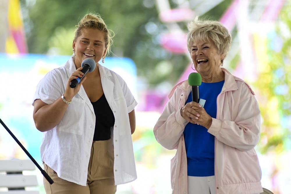 Inductee Rose Snow (right) laughs with Madelyn Strausburg during Wednesday’s Cincinnatus League of Jay County Hall of Fame for a Lifetime of Service induction ceremony in the Farmer’s Building during the Jay County Fair. (The Commercial Review/Ray Cooney)