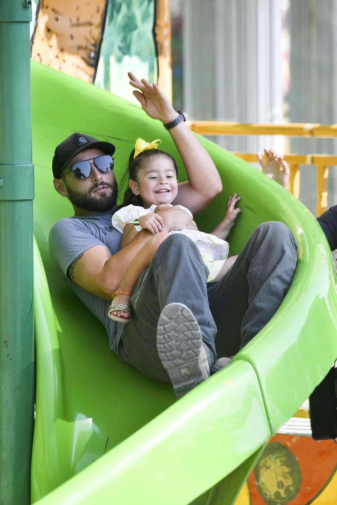 The Jay County Fair concluded Saturday with a full day of rides and amusements and A Touch of Mexico in the Farmer’s Building. Pictured at above, Lane Zaugg and Ivie Gallegos go down a slide in the midway on Saturday afternoon during the final day of the Jay County Fair. Below, a boy from Grupo Floclorico Infantil Macehuani dances during A Touch of Mexico. (The Commercial Review/Andrew Balko)