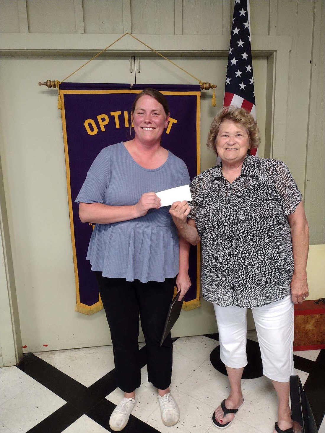 Allison Keen from the Purdue Extension Office of Jay County accepts a $500 check from the Portland Evening Optimist president Linda Aker. (Photo provided)