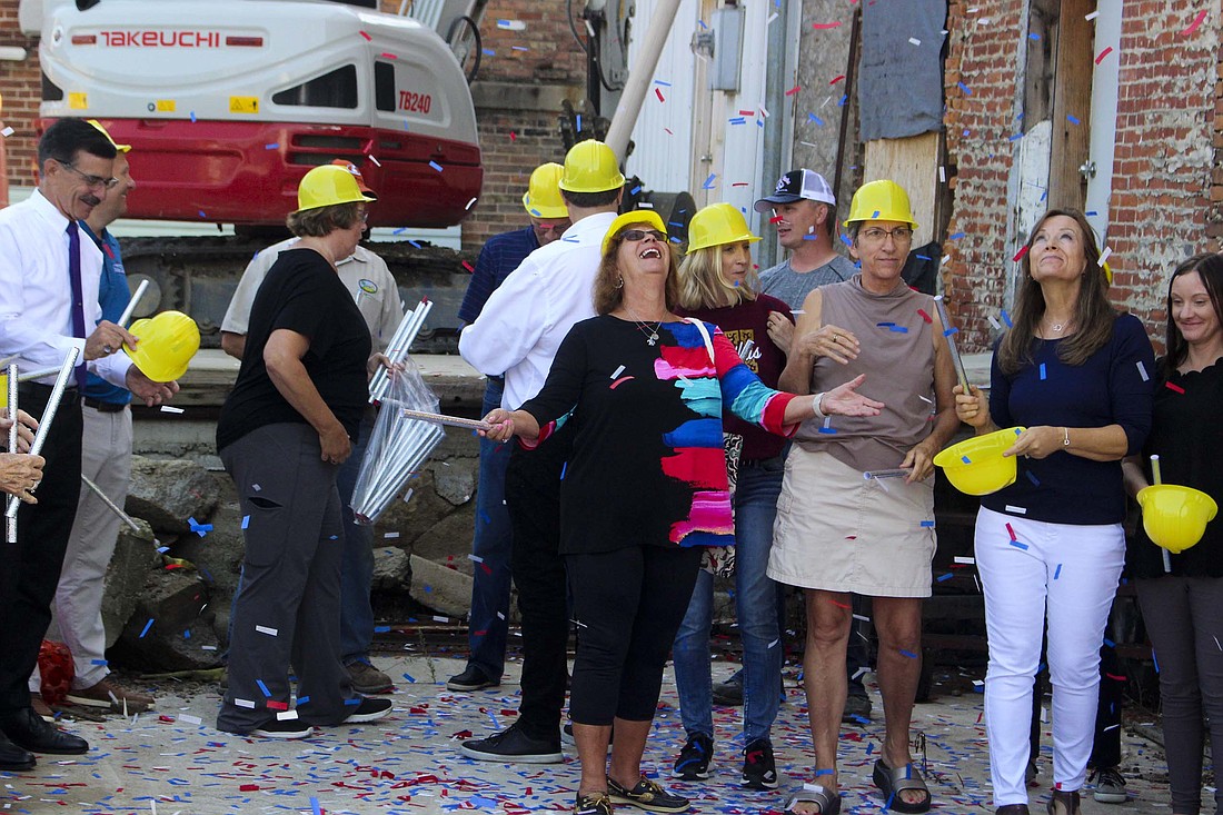 Karen Meiring looks up as confetti falls around her Friday during a groundbreaking ceremony for Fort Recovery Morvilius Opera House. Renovation work on the 141-year-old building is scheduled to begin in the next couple of weeks. (The Commercial Review/Bailey Cline)