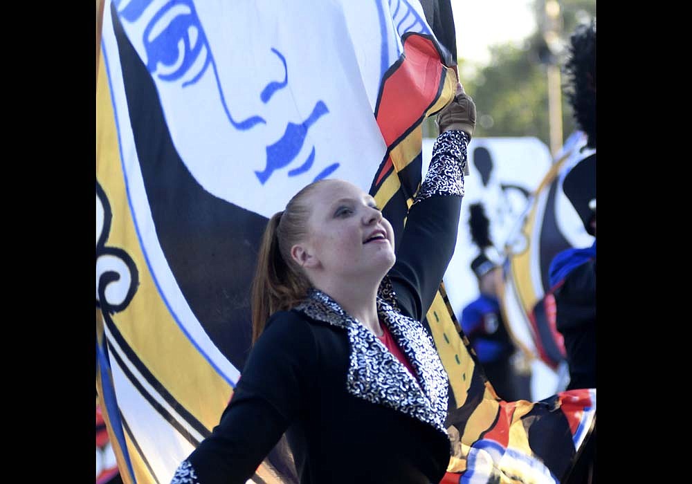 The Jay County High School Marching Patriots followed up their third-place finish in the season-opening contest at Centerville with another third-place finish Friday night during the Jay County Lions Band Contest at Jay County Fairgrounds. Pictured, color guard member Sophia Hoevel spins her flags with the face of a queen on a deck of cards — one of the items highlighting their James Bond-themed show — flying behind her. The Marching Patriots scored 61.25 points while champion Muncie Central won with 68.425 and Centerville earned 66.175. (The Commercial Review/Ray Cooney)