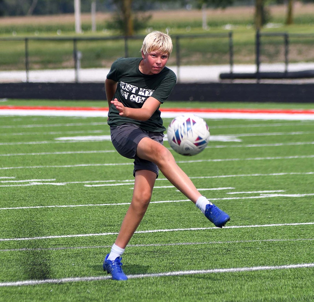 Kevin Dues of Jay County High School shoots at the goal during an early-season boys soccer practice on Monday. The Patriots season opener against Muncie Central on Aug. 20 will be the first official game on the new turf field. (The Commercial Review/Andrew Balko)