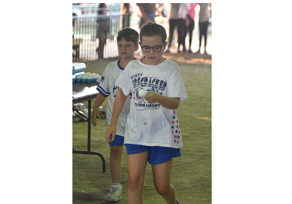 Kelsey Sisco, 10, and Jacob Sisco, 8, of Dunkirk balance eggs on their spoons as part of the Battle of the Barns race at Randolph County Fair on Tuesday. The fair held just south of Winchester will continue through Friday.