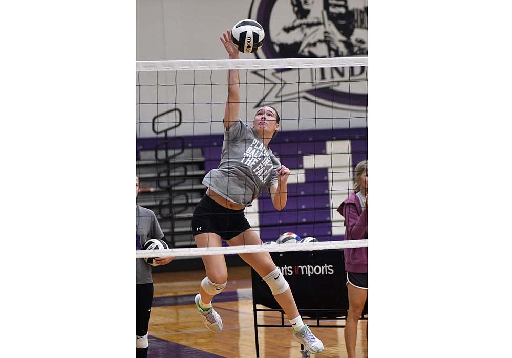 Above, Cameron Muhlenkamp, a sophomore at Fort Recovery High School, attacks a ball in a practice Tuesday afternoon. Middle hitter Karlie Niekamp glides to the right antenna to catch a ball during a drill. The Indians will open their season on Aug. 17 at Russia. (The Commercial Review/Andrew Balko)