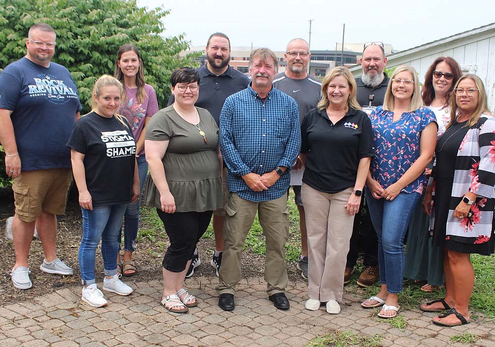 Jay County Drug Prevention Coalition announced the name of its new sober living facility, The Vision on Votaw, on Wednesday. Pictured, coalition members, representatives from IU Health Jay and naming contest winner Shalee Myron, stand in the backyard of the house at 422 W. Votaw St., Portland. (The Commercial Review/Bailey Cline)