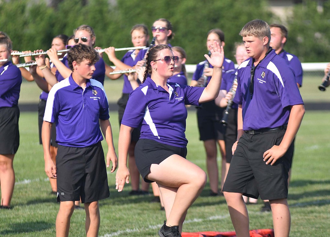 Grace Lochtefeld moves like a robot alongside Russel Hart (left) and Tony Evers in the Fort Recovery High School band’s performance at the ice cream social on Friday. This year’s show takes inspiration from the Industrial Revolution and the “The Terminator” series. (The Commercial Review/Andrew Balko)