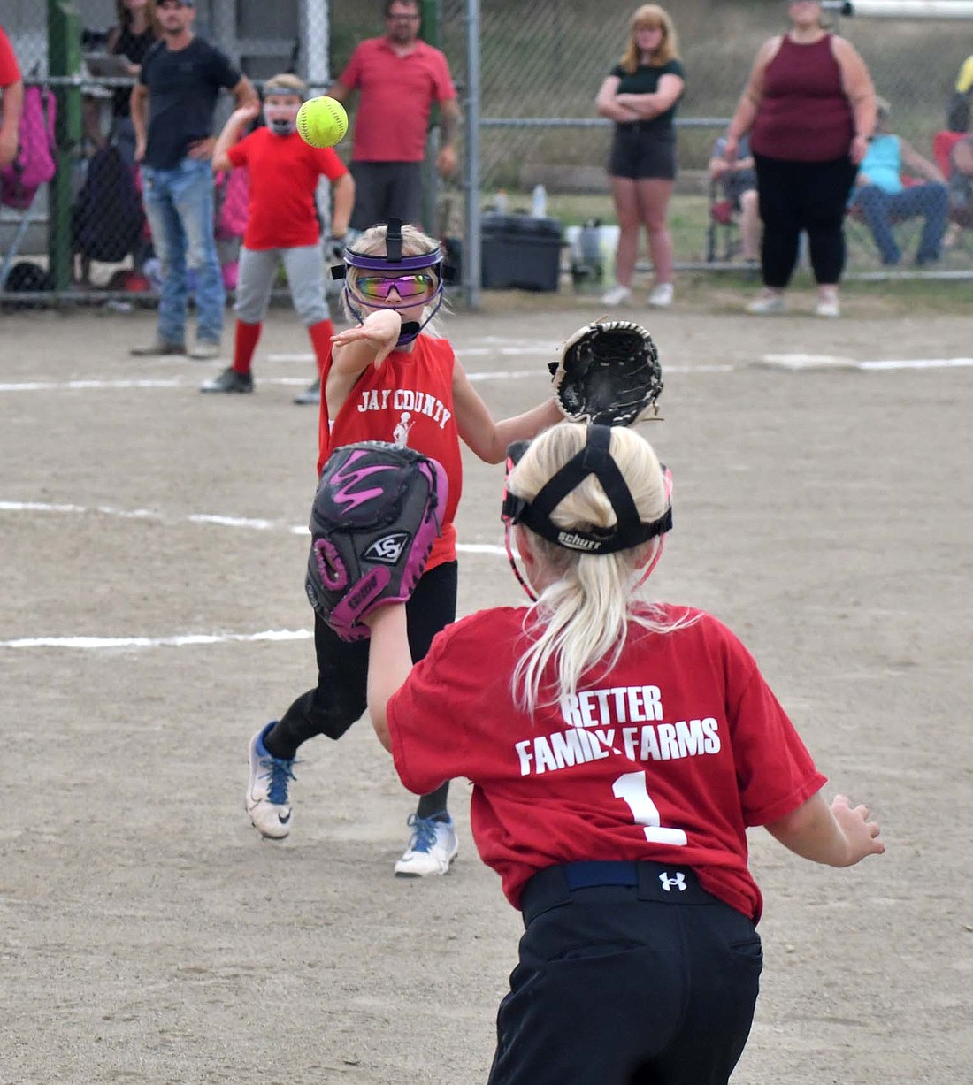 Dunkirk Junior League held its opening day for the first time since 2018 on Monday afternoon. Above, Hayden Guggenbiller of Pioneer Packaging throws over to first base during the minor girls division opener. (The Commercial Review/Andrew Balko)