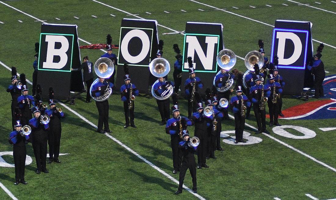 At the end of the Jay County High School Marching Patriots show, the props that show silhouettes of James Bond through most of the performance are flipped to review his name. The show, titled “You Know My Name,” features music from the Daniel Craig era of the long-running movie franchise. (The Commercial Review/Ray Cooney)