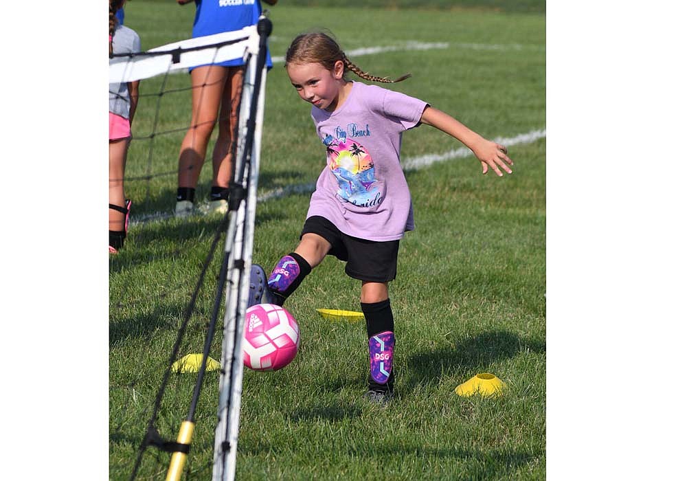 Rosalie McLaughlin shoots for the goal during the Jay County High School youth soccer camp on Tuesday. The three-day camp had about 50 participants that got to work with boys and girls varsity soccer players. (The Commercial Review/Andrew Balko)