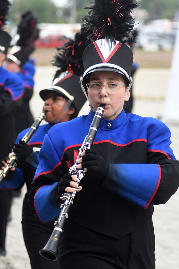 Ava Franks plays the clarinet for the Marching Patriots on what was, in places, a sloppy track in front of the grandstand at the Indiana State Fair. (The Commercial Review/Ray Cooney)