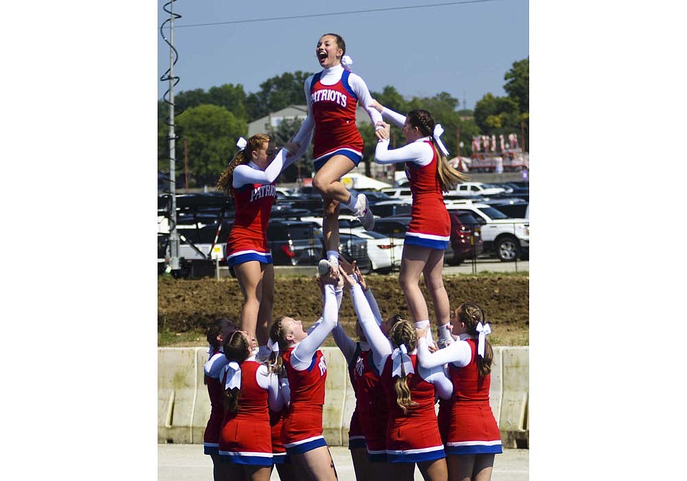 Jay County High School’s varsity cheerleaders hit a stunt during their Indiana State Fair routine Saturday. The Patriots scored 203.1 points, falling just one tenth of a point behind Tri-West to finish as second in the state fair field of three squads in the small varsity no music division. (The Commercial Review/Ray Cooney)