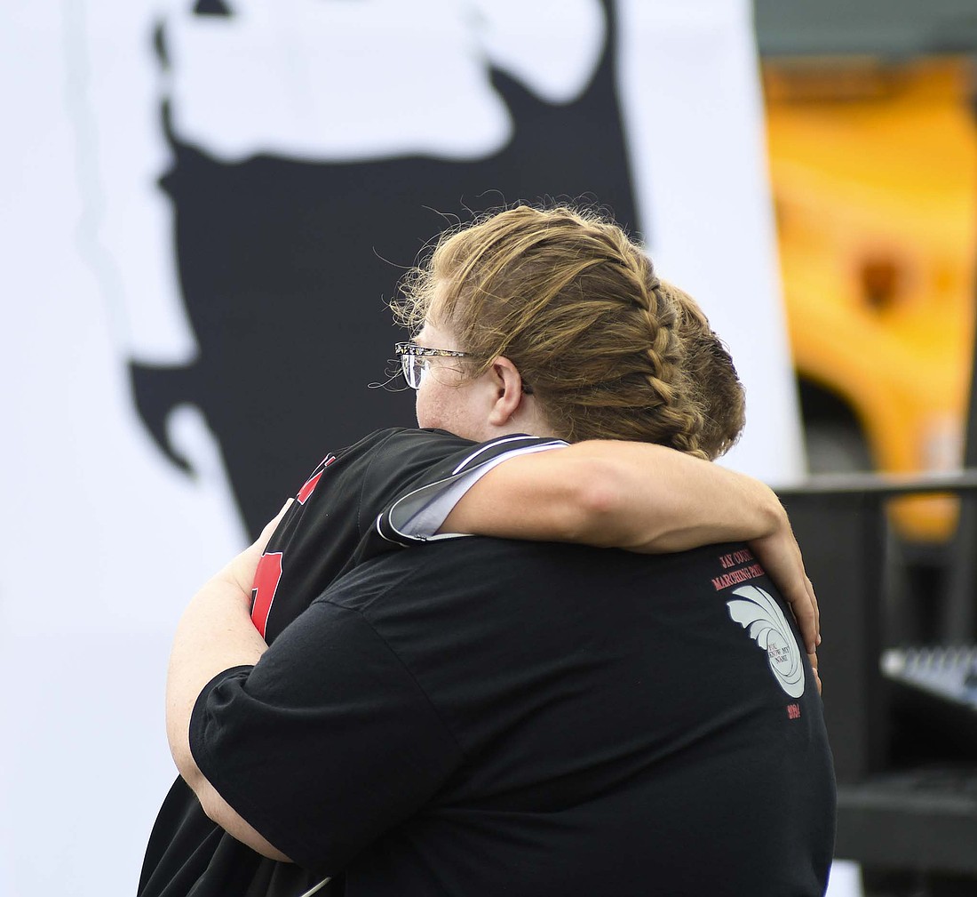 Jay County High School Marching Patriots drum major Gabe Pinkerton gets a hug from his mom Catherine following the band’s preliminary performance Friday at the Indiana State Fair in Indianapolis. JCHS advanced to the Sweet 16 and closed the evening with a fifth-place finish. (The Commercial Review/Ray Cooney)