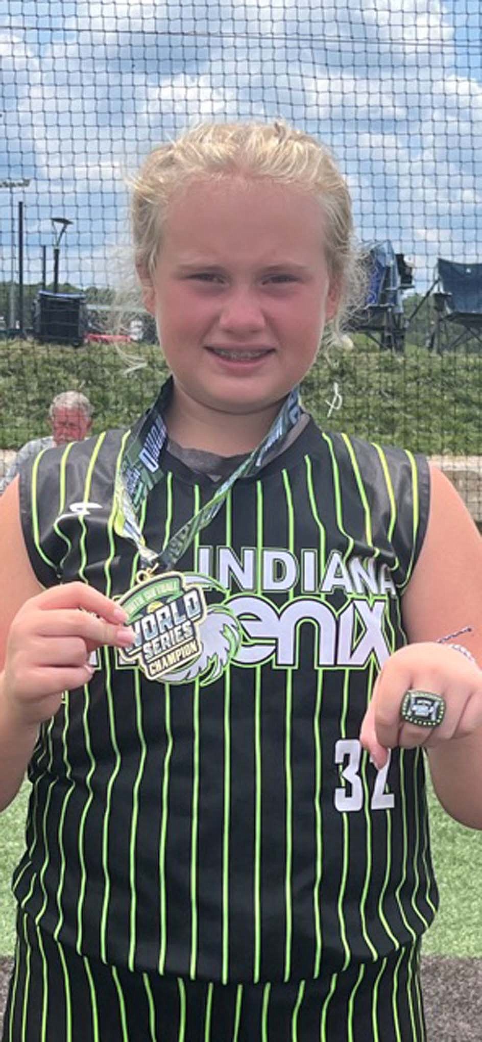 Pictured, Zoe McLaughlin holds her medal from the Lake of Ozark’s World Series Championship in Camdenton, Missouri. McLauglin, an eighth grader at Jay County, drove in three runs and only gave up one run over four innings pitched to help the Indiana Phoenix 12-and-younger team to a 7-6 victory. (Photo provided)
