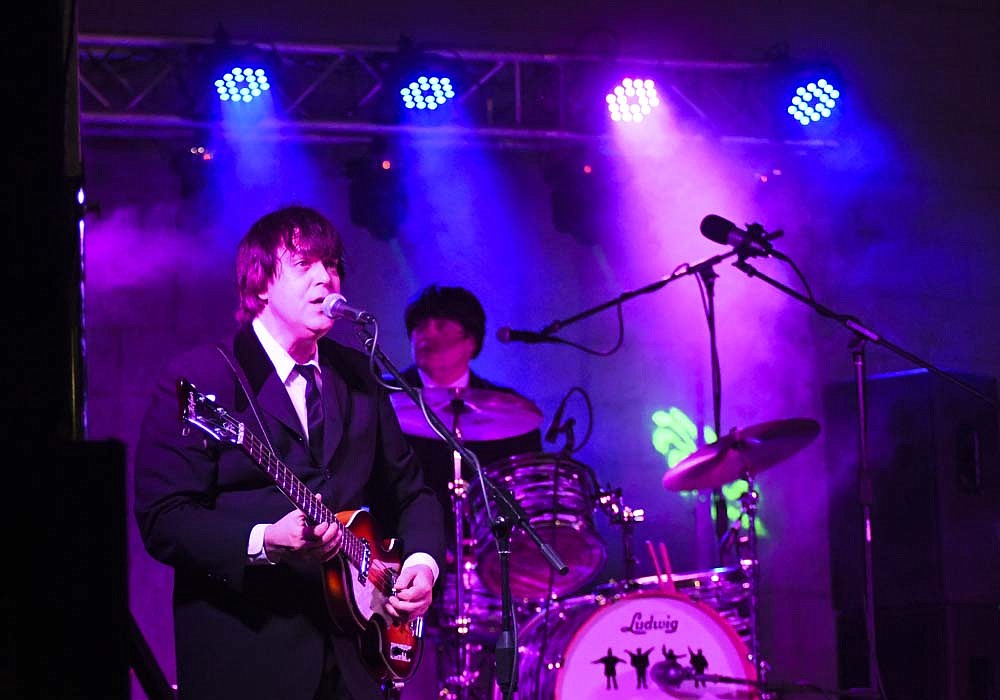 E.S. Hider, portraying Paul McCartney, sings “Hey Jude” as an encore at the conclusion of Thursday’s Liverpool Lads concert as part of Arts Place’s Hudson Family Park Amphitheater Concert Series. The Beatles tribute band was the third this summer for the series, which will conclude with Sounds of Summer: A Beach Boys Tribute at 7 p.m. Thursday, Sept. 12. (The Commercial Review/Ray Cooney)