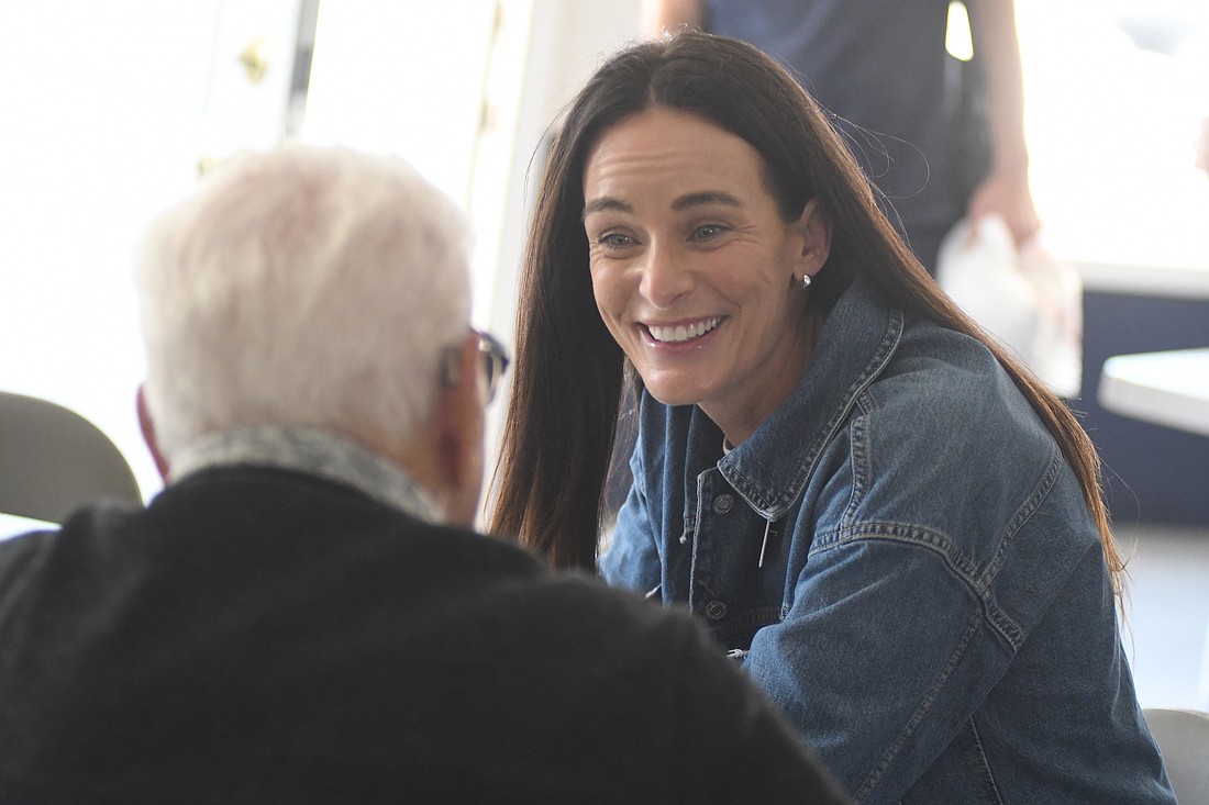 Congressional candidate Kiley Adolph, a Democrat, grins while chatting with Portland resident Fred Bailey during a visit Saturday to Jay County. She also took part in the Gas Boom Days parade in Redkey. (The Commercial Review/Ray Cooney)