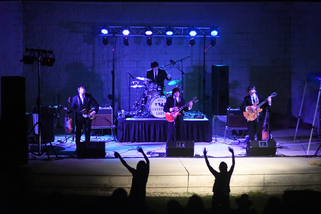 Concertgoers wave their arms in the air during Liverpool Lads’ encore performance of “Hey Jude” on Thursday during the concert at the Hudson Family Park Amphitheatre. The Beatles tribute band was a performance in Arts Place’s Hudson Family Park Amphitheater Concert Series, which will conclude with Sounds of Summer: A Beach Boys Tribute at 7 p.m. Thursday, Sept. 12. (The Commercial Review/Ray Cooney)