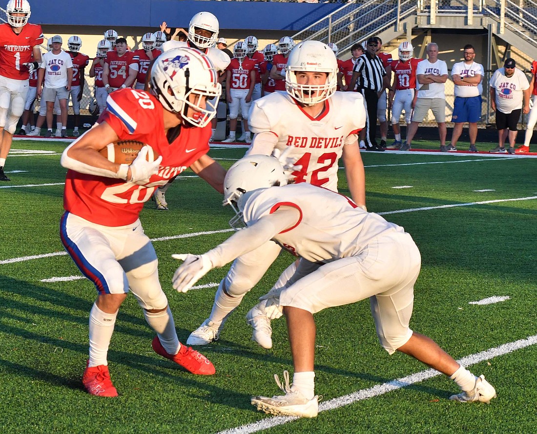 Jay County High School senior Benson Ward braces for impact after completing a catch in Friday’s scrimmage against Richmond. Ward is the leading receiver returning for the Patriots. He went for 212 yards on 13 receptions for four touchdowns last year. (The Commercial Review/Andrew Balko)