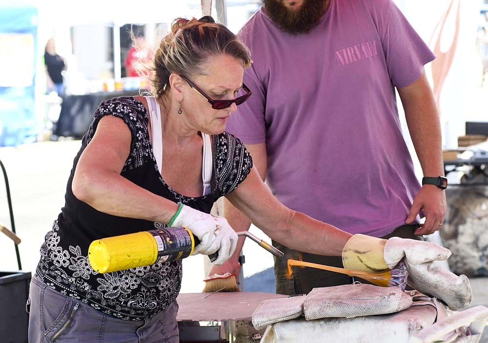 The Glass Days festival was held Saturday in Dunkirk. Pictured above, Lisa Pelo of Indy Fused Glass uses a torch to work on a piece. (The Commercial Review/Ray Cooney)