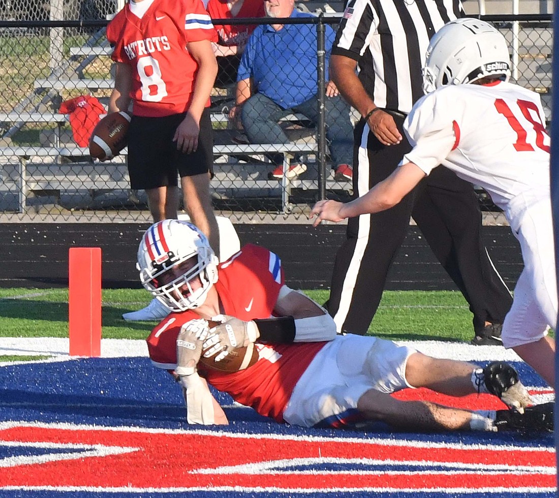 Jay County High School’s Ben Crouch slides in the end zone to catch a touchdown pass during the Patriots’ scrimmage against Richmond on Aug. 16. JCHS opens their season Friday at Blackford. (The Commercial Review/Andrew Balko)