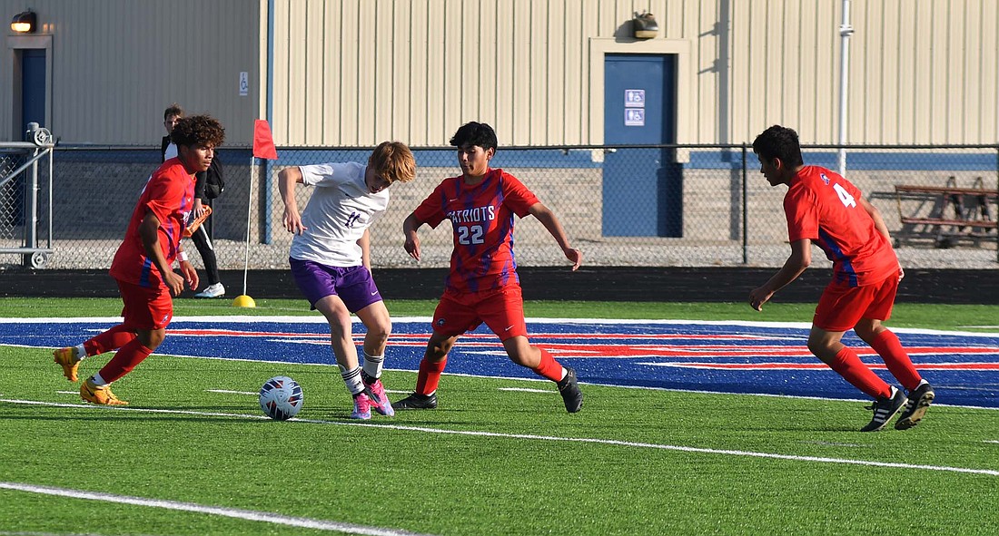 Jay County High School boys soccer defenders Osmar Gonzalez (11), Iker Nelson (22) and Ashton Castillo (4) collapse in on Muncie Central forward Toby Gruver during the season opener Tuesday. The three defenders along with goalie Peyton Yowell held the Bearcats to zero goals in the 1-0 victory. (The Commercial Review/Andrew Balko)