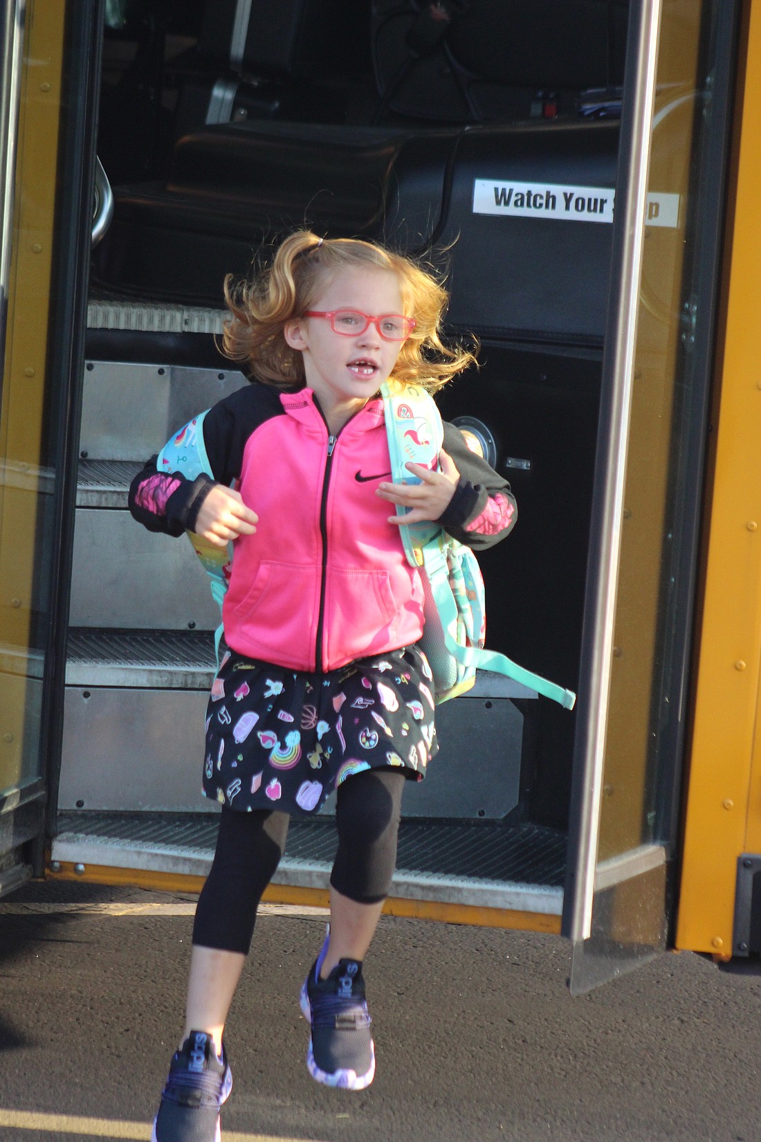 Fort Recovery Local Schools started its school year Wednesday. Pictured, kindergartener Sofia Lessing steps off the school bus Wednesday morning at Fort Recovery Elementary/Middle School. (The Commercial Review/Bailey Cline)