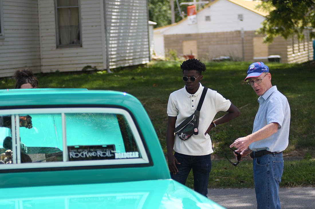 Tony Morgan (right) and Jed Adewuyi check out one of the vehicles during the car show at Webster Depot Park during Saturday’s Glass Days festival in Dunkirk. (The Commercial Review/Ray Cooney)