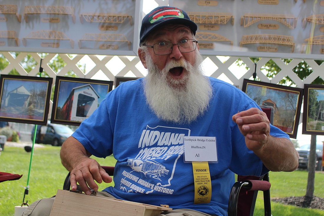 Al Renken exclaims while shaping toothpicks for his latest model design Thursday morning at Jay County Fairgrounds. Renken, a Bluffton resident and member of Indiana Covered Bridge Society, has been building bridge models out of toothpicks for six years. He attends festivals through Indiana, including the Tri-State Antique Engine and Tractor Show in Portland this week, to share his collection. (The Commercial Review/Bailey Cline)